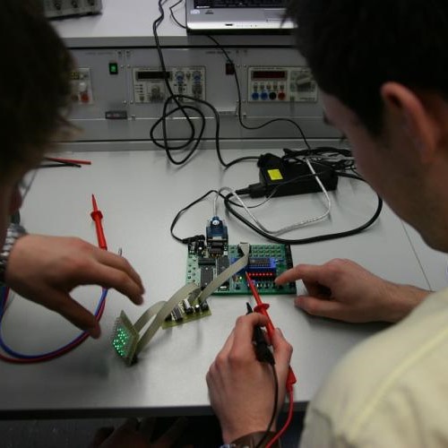 Students interacting with a circuit and oscilloscope