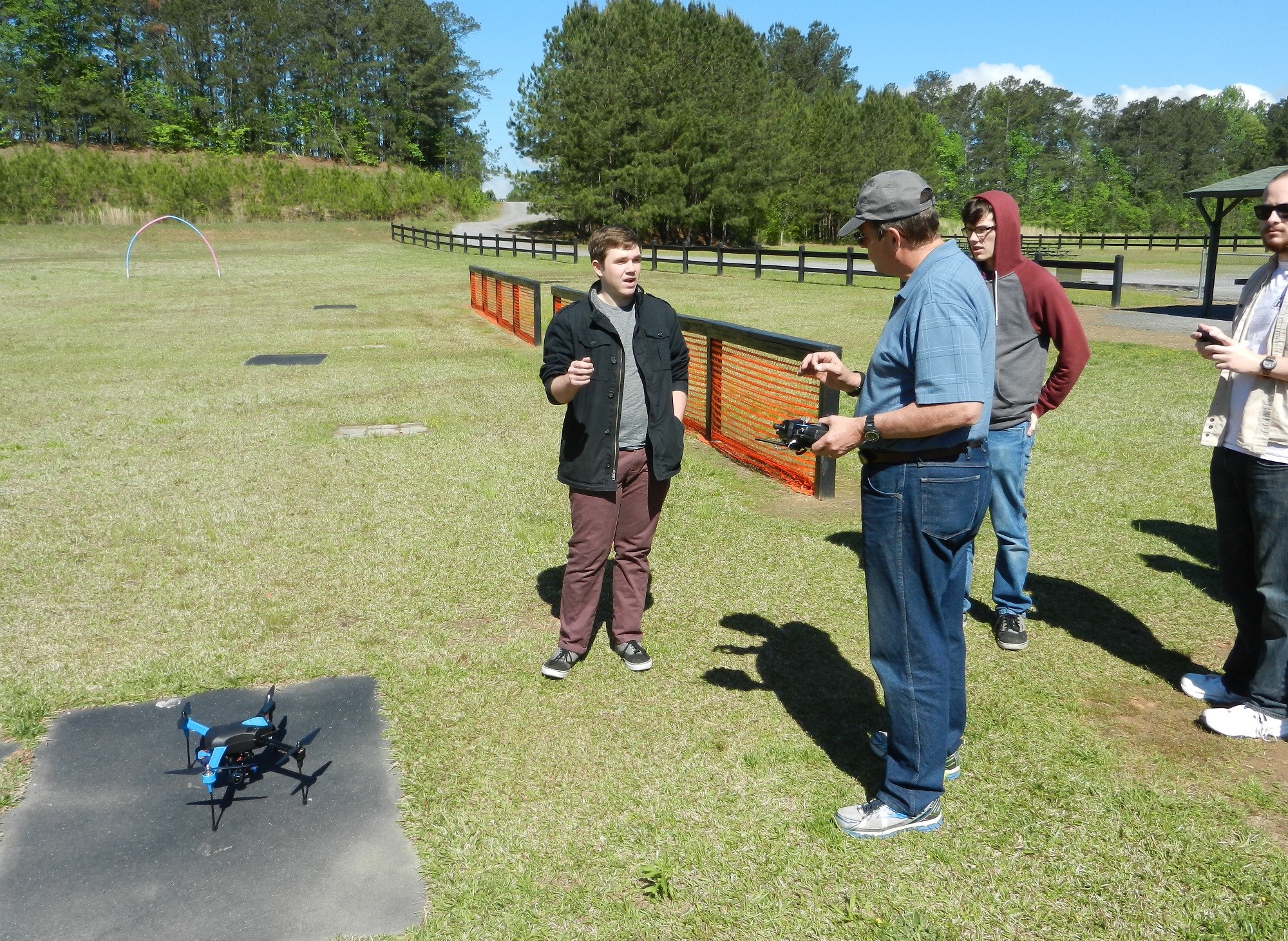 People discussing near a quadcopter