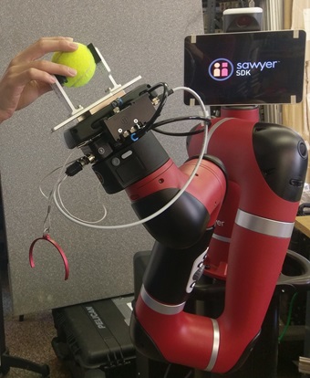 Robot arm holding a tennis ball