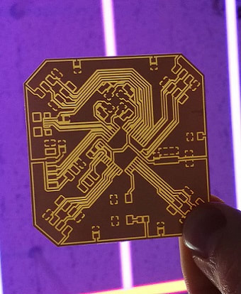 PCB held against a purple background